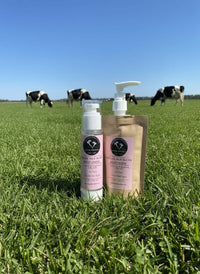 Korean Facial Care Kit featuring cleanser and moisturizer on grass with cows in the background.