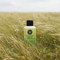 Tallow-Licious Winter Skin Defense Kit bottle in a grassy field for natural skincare hydration.