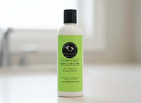 Tallow & Aloe Gentle Cleanser bottle on a table showcasing its pure and nourishing formula.